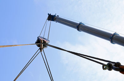 Huge hydraulic arm of a powerful crane for lifting heavy loads at an industrial site