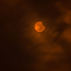 Low angle view of moon at sunset