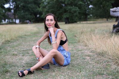 Thoughtful woman sitting on field