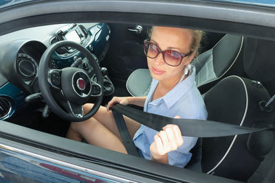 Portrait of woman sitting in car