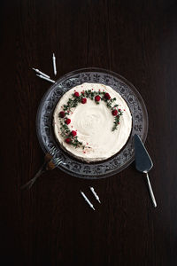 High angle view of birthday cake and candles served on table