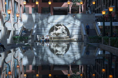 Digital composite image of people in illuminated city