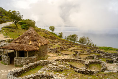 Scenic view of neolithic village against sky