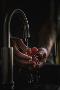 Close-up of hand holding glass of water