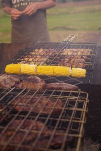 Man preparing food on barbecue grill