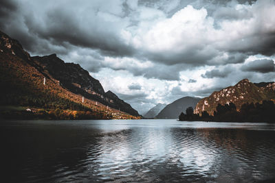 Scenic view of lake and mountains against sky