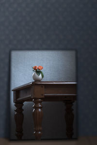 Close-up of toy on table against wall at home