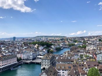 High angle view of river amidst buildings in city against sky