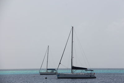 Sailboats on sea against sky