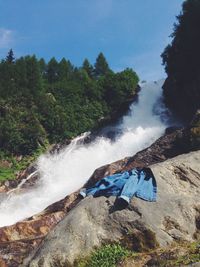 Scenic view of waterfall against sky