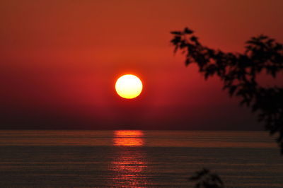 Scenic view of sea against orange sky