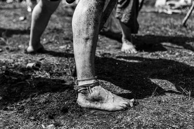 Low section of man standing on field