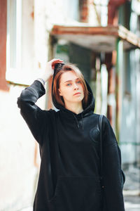 Portrait of beautiful young woman standing outdoors