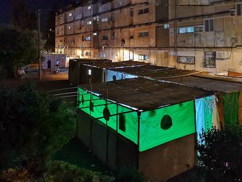 High angle view of building by trees in city