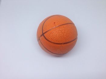 Close-up of orange ball against white background