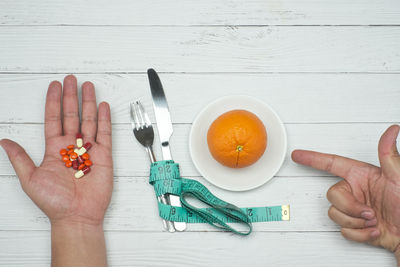 High angle view of person holding food on table