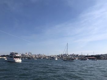 Sailboats in sea against sky
