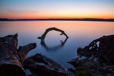 Scenic view of lake against sky during sunset