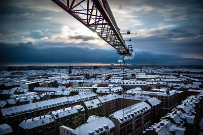 Cranes against cloudy sky