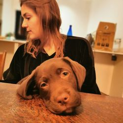 Portrait of woman with dog at home