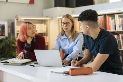 Young people studying in library