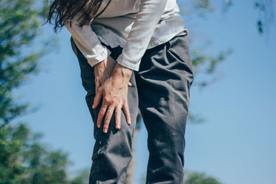 Midsection of man standing by tree