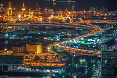 High angle view of illuminated buildings in city at night