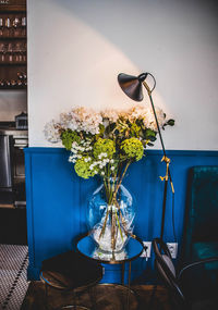 Close-up of potted plant on table against wall