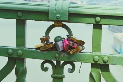 Close-up of padlocks hanging on railing