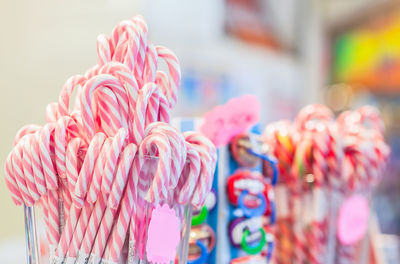 Close-up of candy canes in containers for sale in store