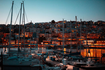 Sailboats moored at harbor