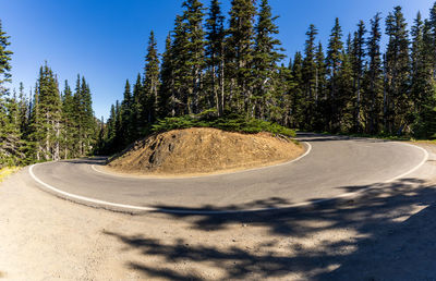 Road amidst trees against sky