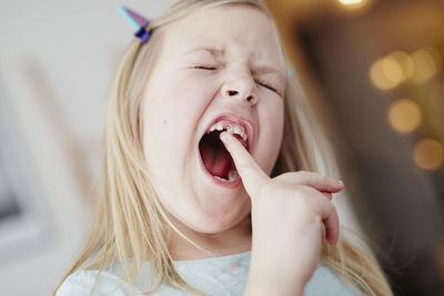 Girl moving milk tooth