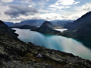 Scenic view of lake and mountains against sky