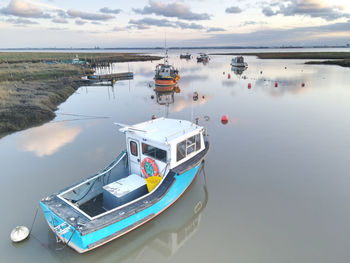 Boats moored in sea against sky