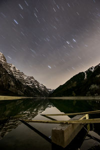 Scenic view of lake against sky at night