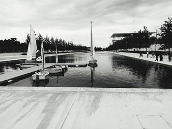 Swimming pool by river against sky