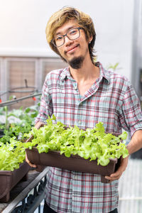 Portrait of young man standing outdoors