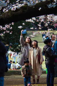 People on flower against trees