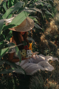 Woman holding flowers on field