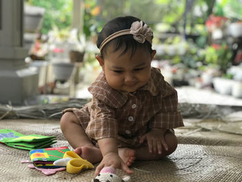 Cute baby girl playing with toys
