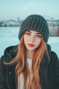 Portrait of beautiful young woman in hat