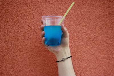 Close-up of hand holding drink