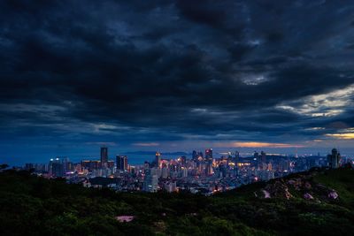 Cityscape against cloudy sky