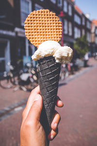 Hand holding ice cream cone