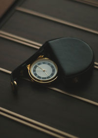 High angle view of clock on table