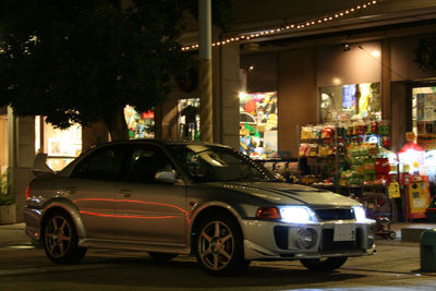 Cars parked on illuminated street at night