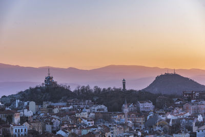 Townscape against sky during sunset