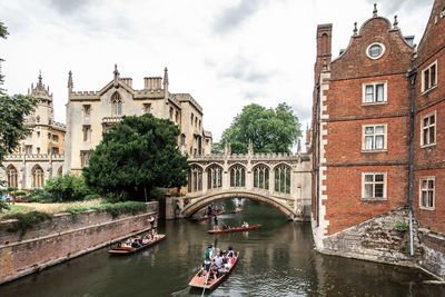 Arch bridge over canal against buildings in city