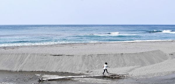 Full length of man on beach against sky